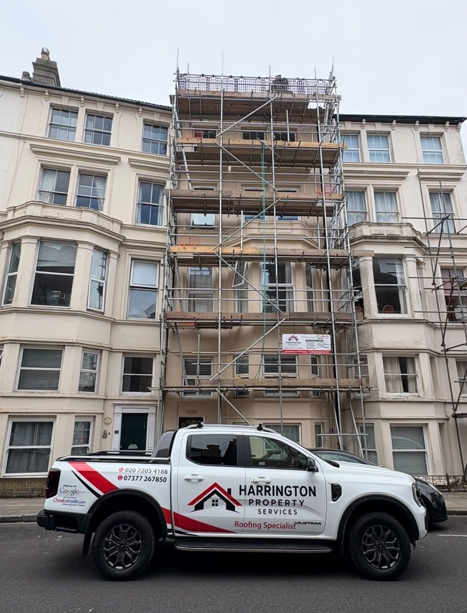Harrington Property Services liveried van outside a scaffolded stucco terrace